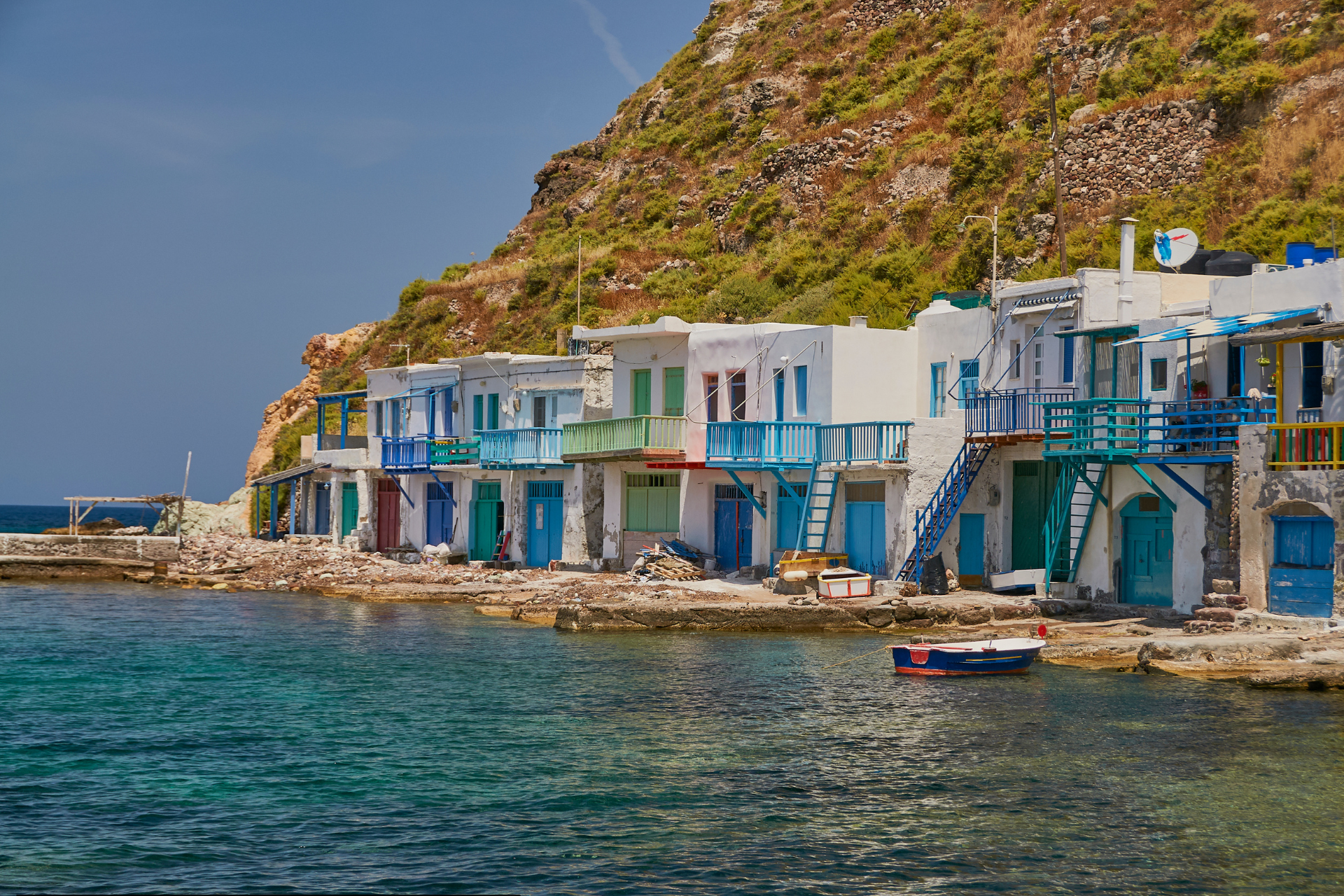 Fishing village in Milos with colorful houses on the sea during a sailing tour around the island