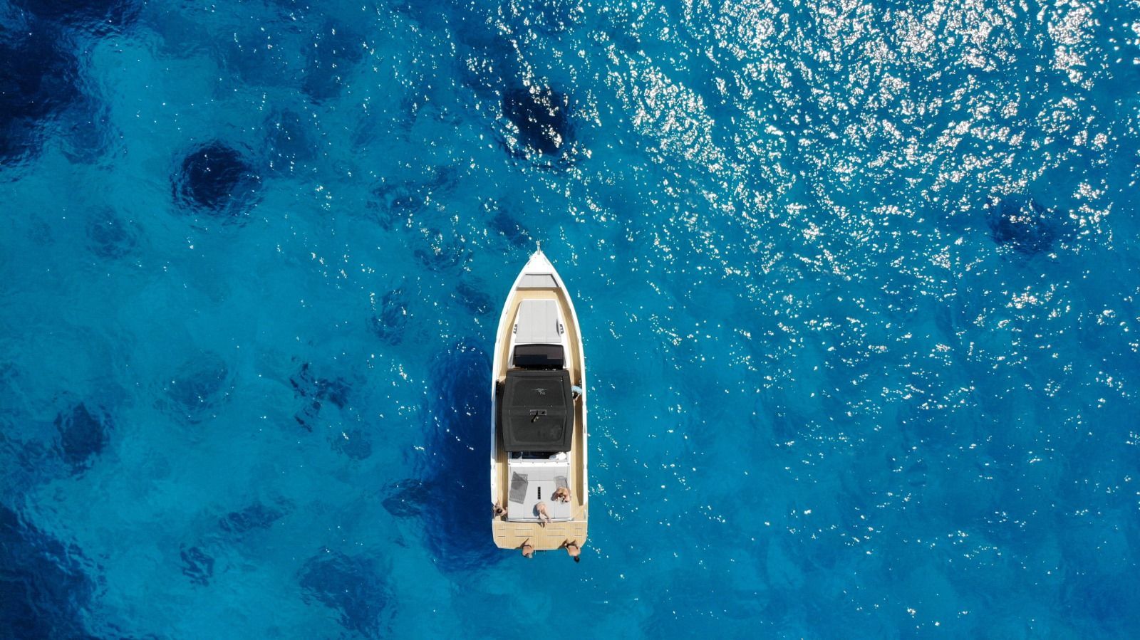 private yacht charter Mykonos aerial boat in turquoise water