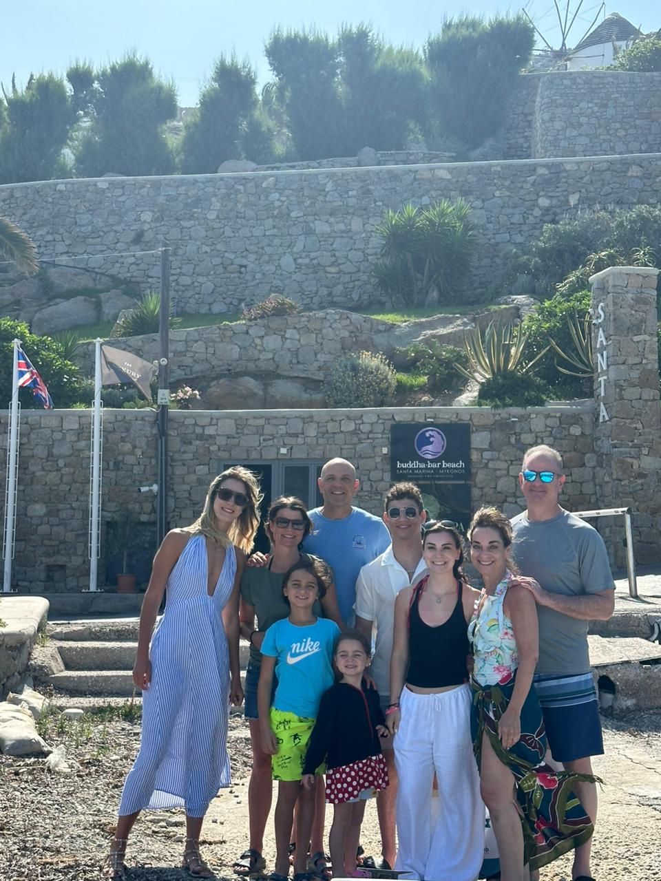 Host with guests at Ornos embarkation point, Mykonos. Private and semi private yacht cruises