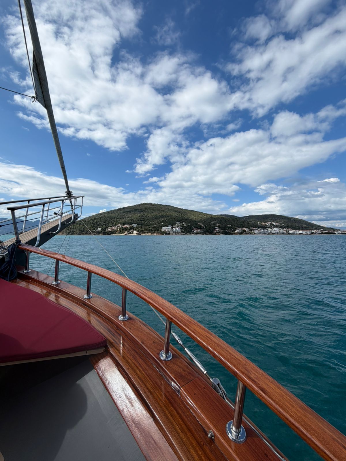 Luxury cruise from Athens in the Saronic Gulf with sea view from yacht deck and coastline in the bac