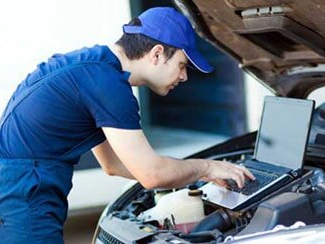 A technician performing an air conditioning repair near Wells, ME