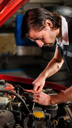 Man performing engine and brake repair in Kennebunk, ME Man performing engine and brake repair in Kennebunk, ME