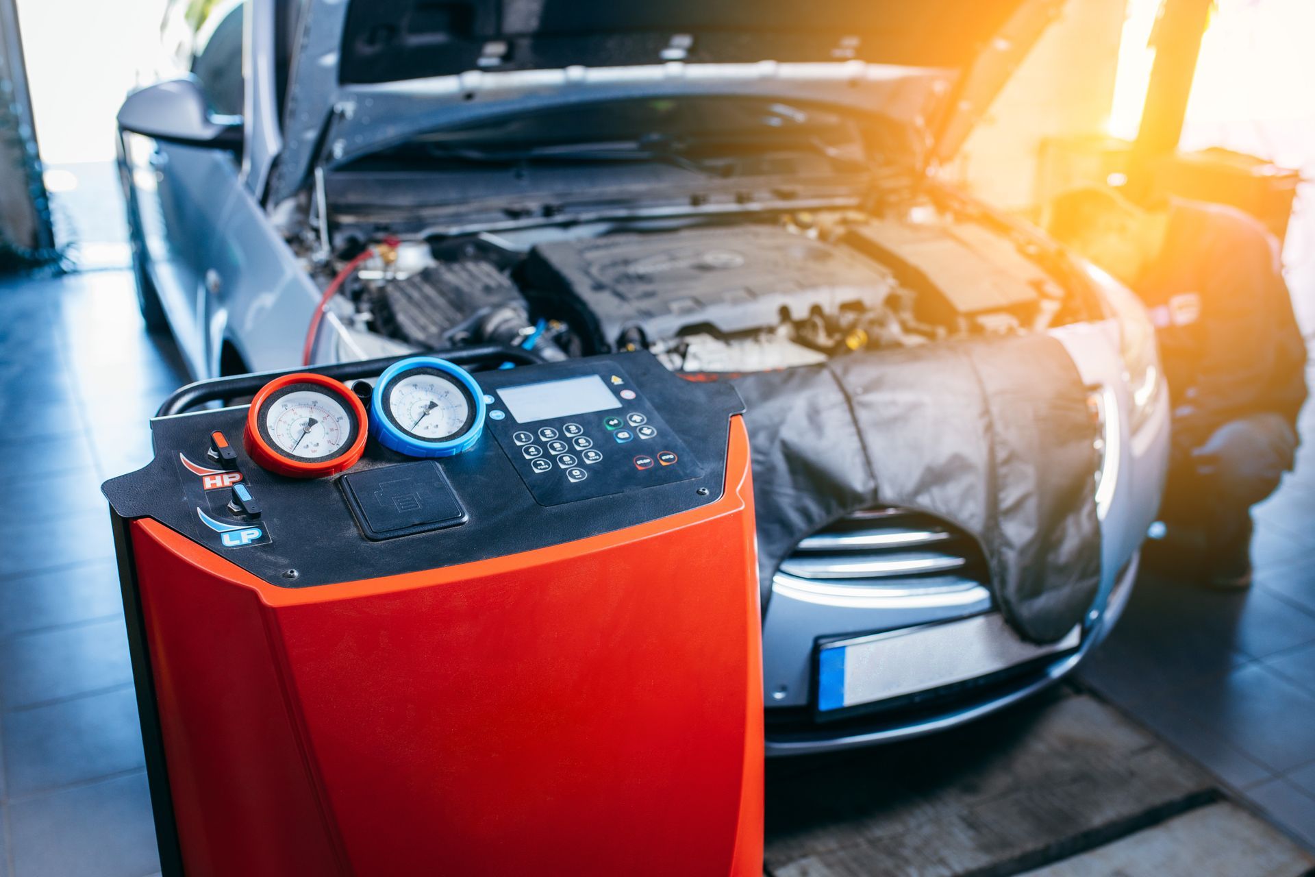 Technician performing auto air conditioning repair on a vehicle in Sanford, ME