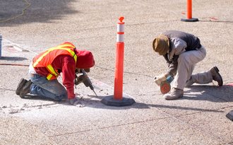 two technicians drilling the ground surface