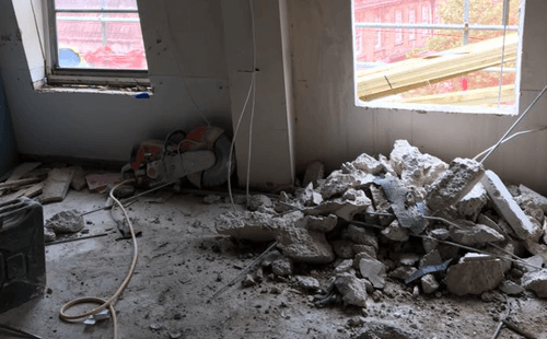 concrete building demolished through controlled remote demolition