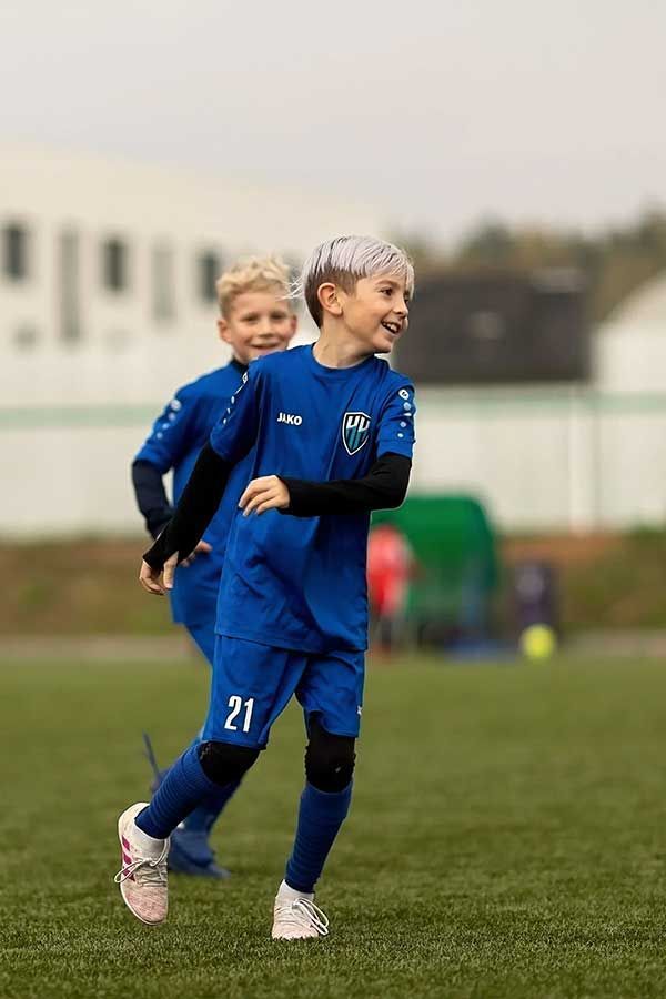 Boys in blue playing soccer