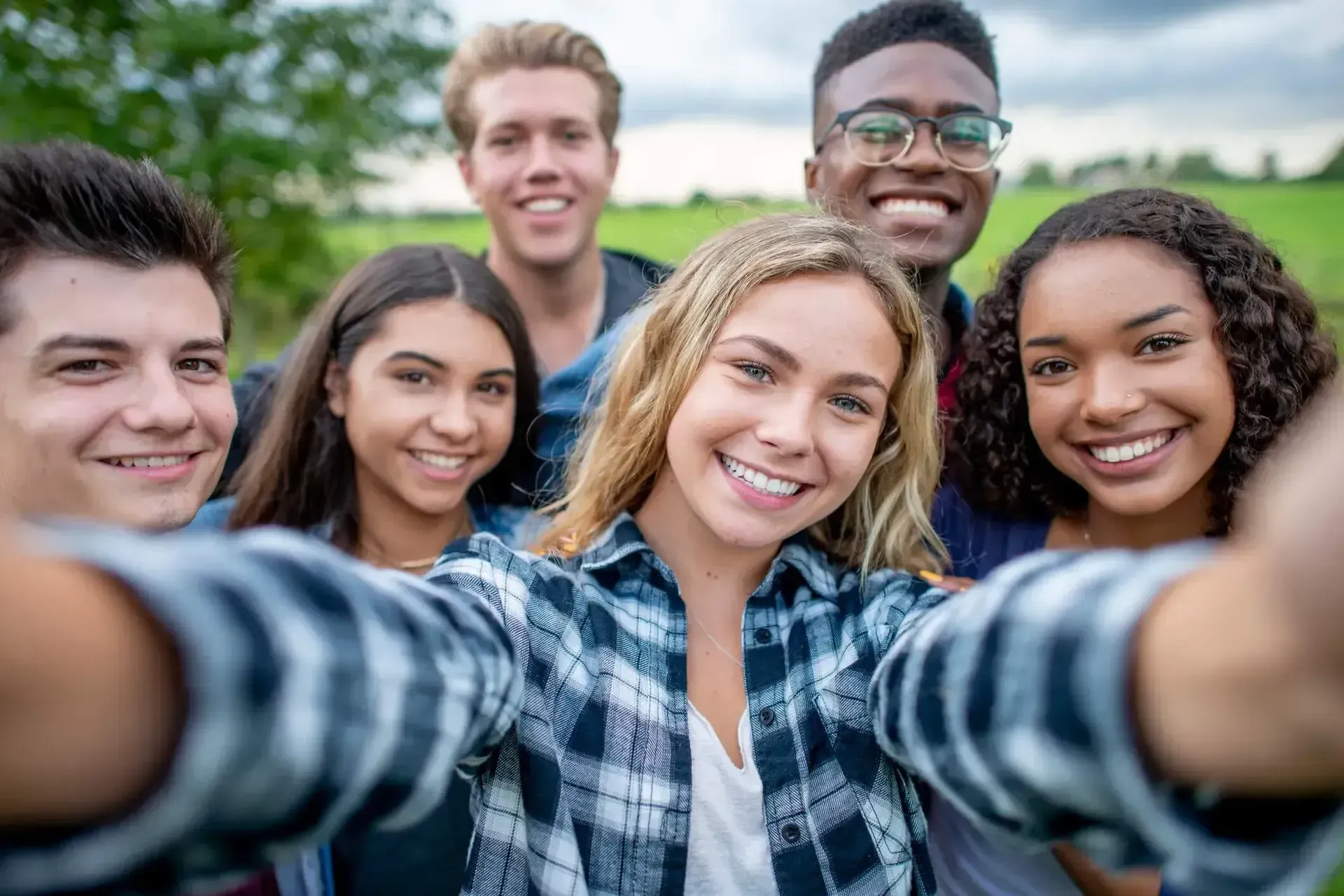 A group of young people are taking a selfie together.