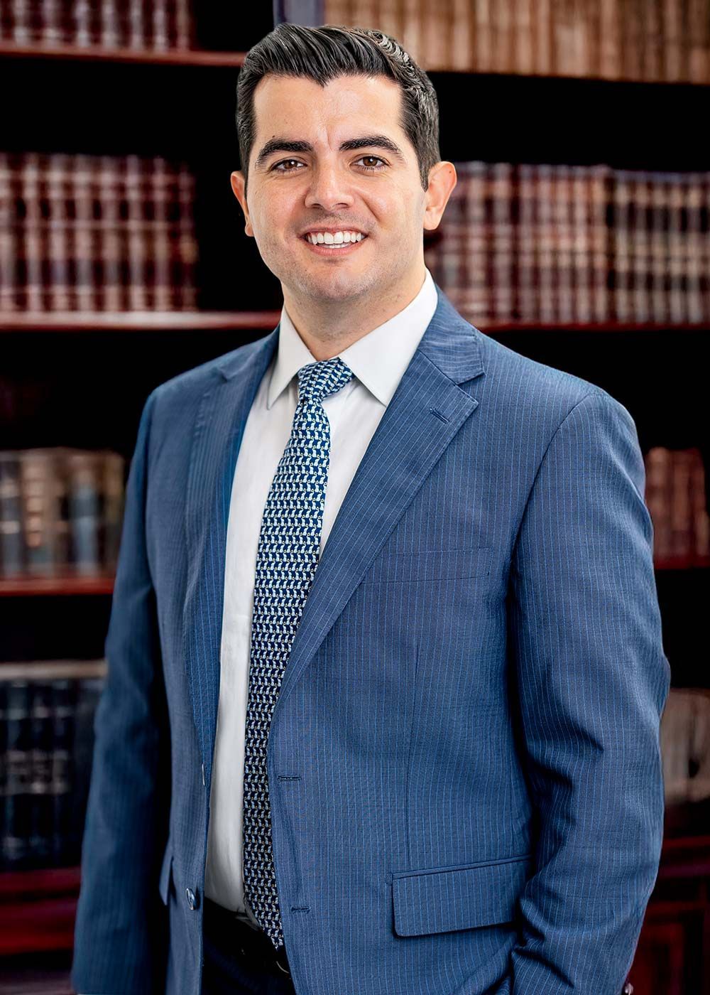 A man in a suit and tie is smiling for the camera.