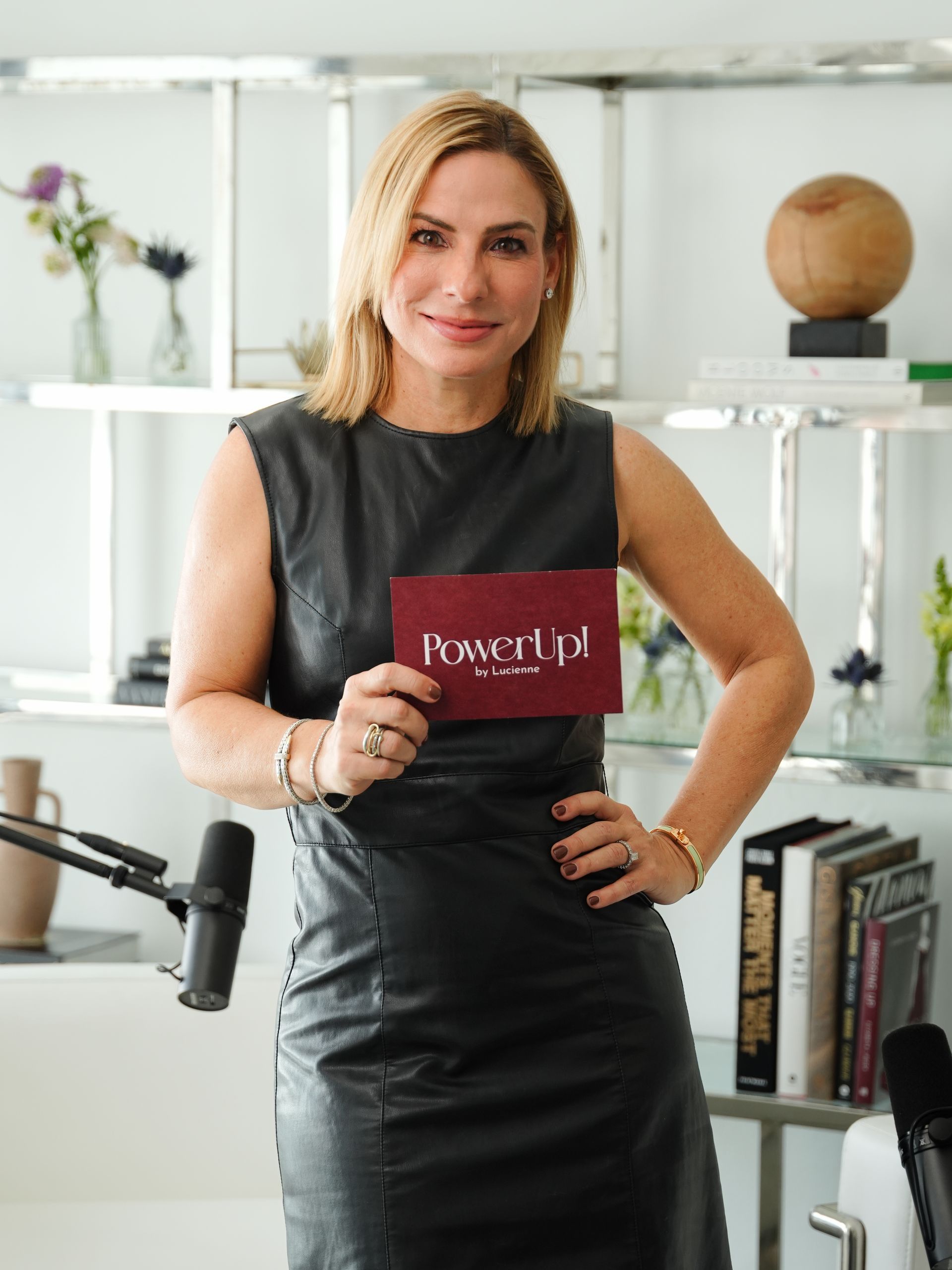 Lucienne in black dress holding a 