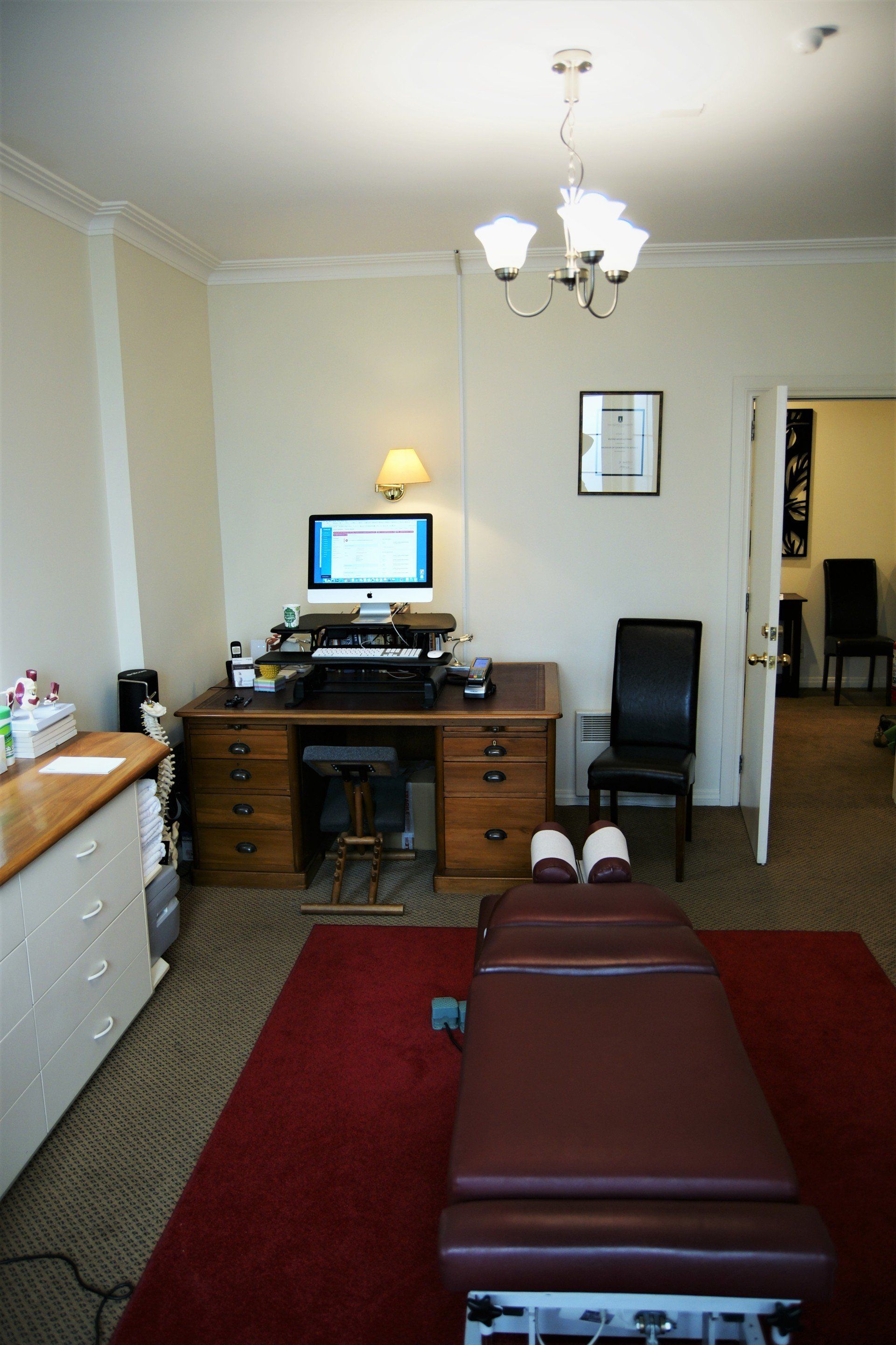 A room with a desk a chair and a computer