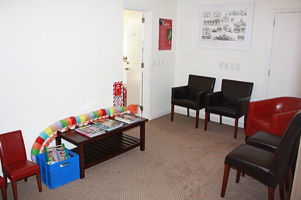 A waiting room with chairs and a coffee table