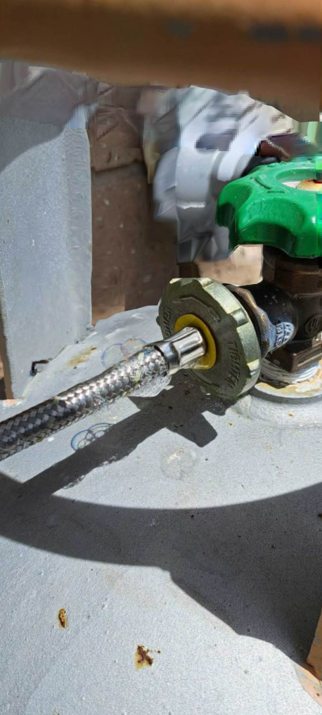 A close-up shows a propane tank with a green valve and a connected silver hose.