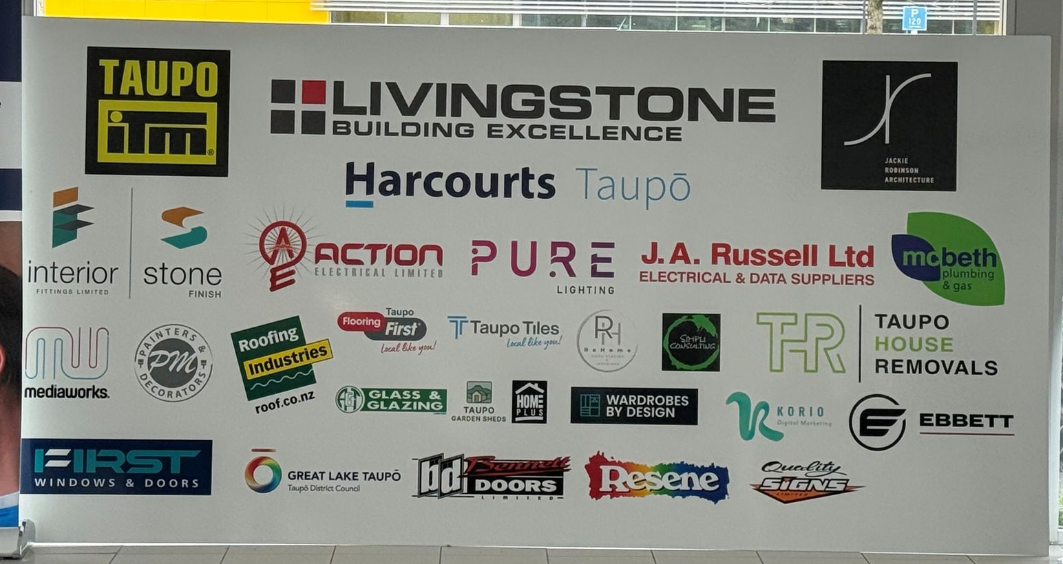 Sponsors' logos displayed on a white background, including Taupo, Livingstone, and Harcourts.