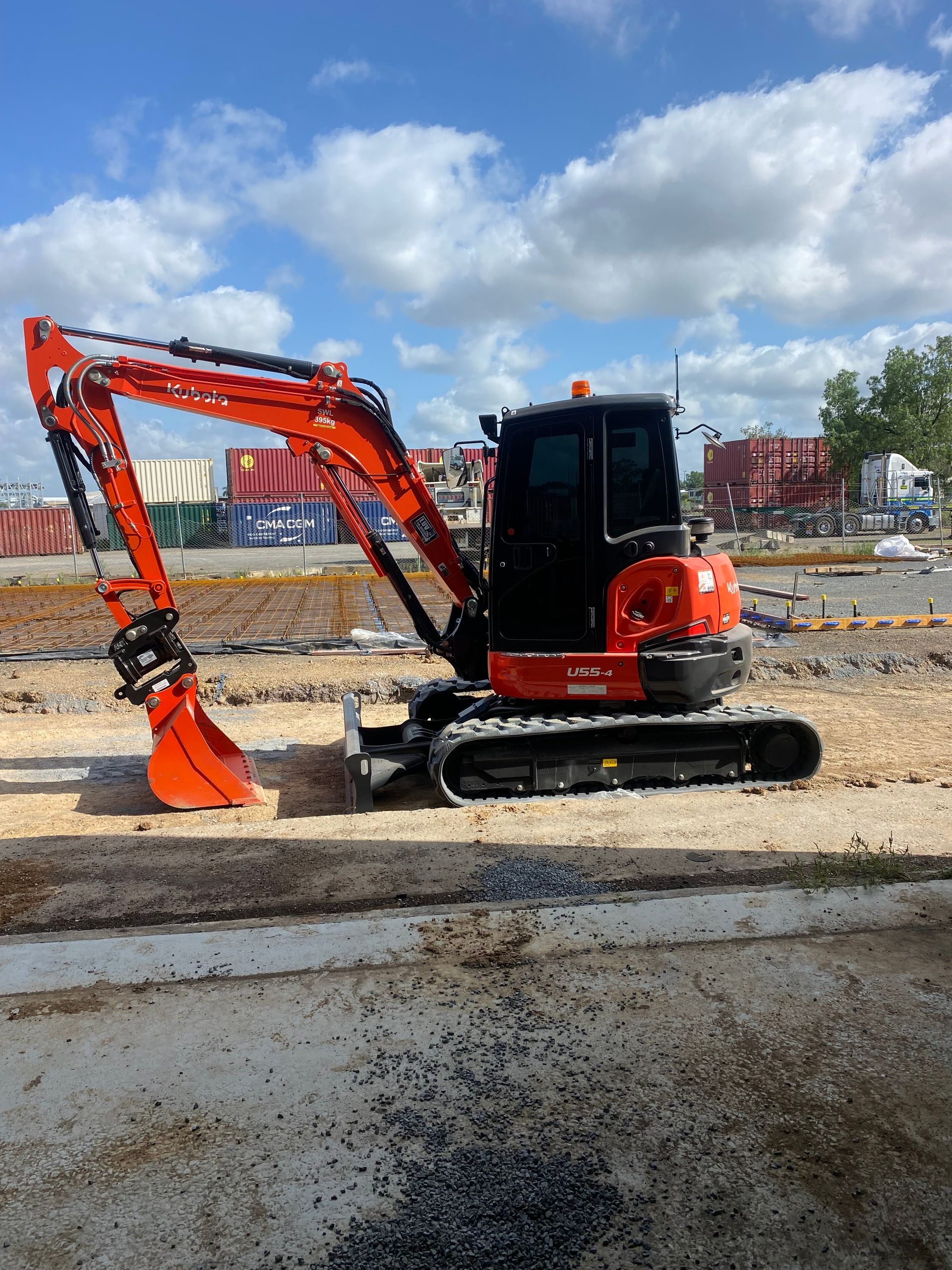Yellow Excavator Bucket Filled with Dirt, at A Construction Site — KAT Earthmoving In Nine Mile, QLD