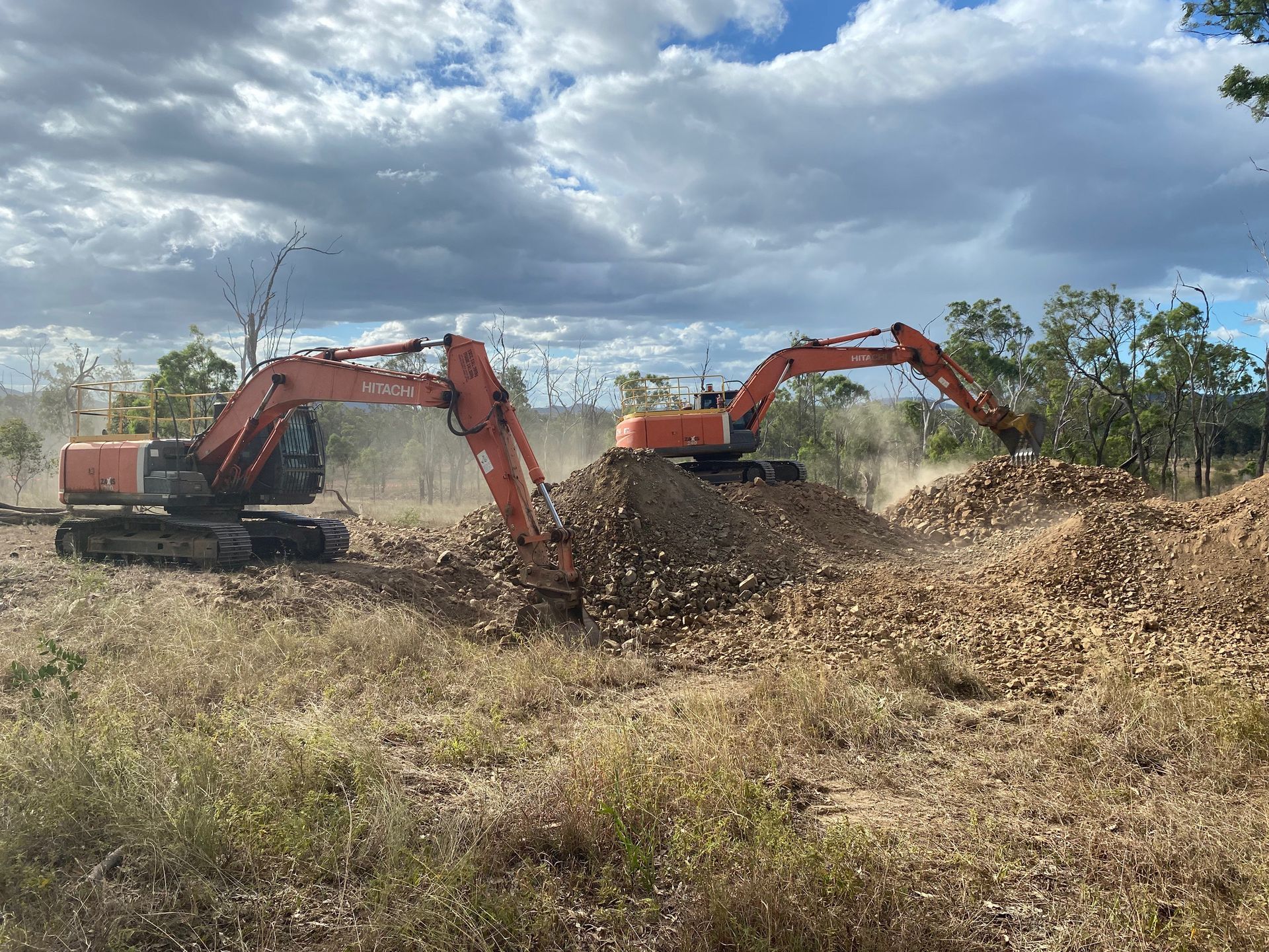 Yellow Excavator on A Trailer at A Construction Site Against a Blue Sky — KAT Earthmoving In Nine Mile, QLD