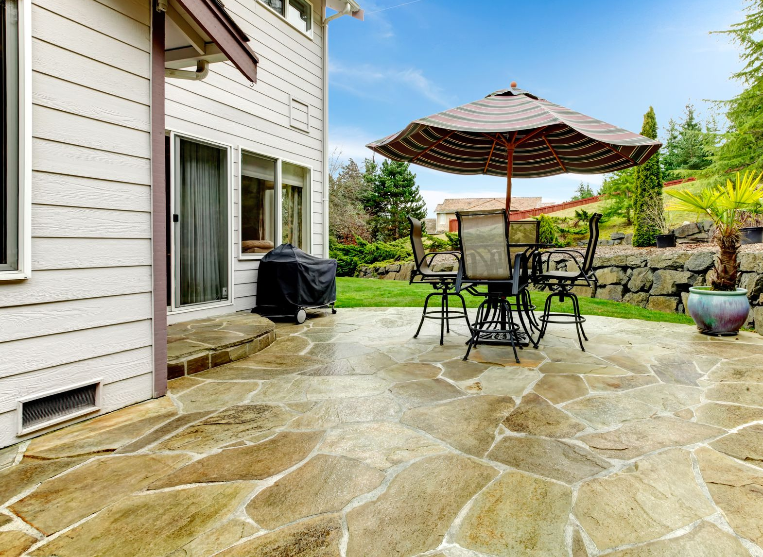 A group of construction workers are working on a concrete walkway.