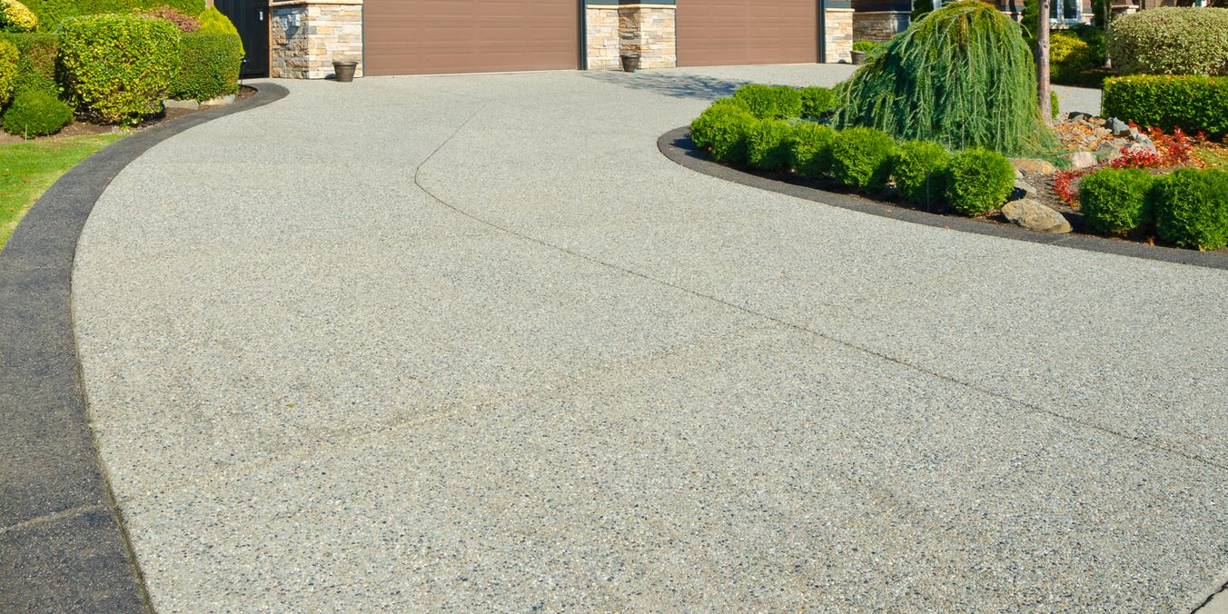A group of construction workers are working on a concrete walkway.