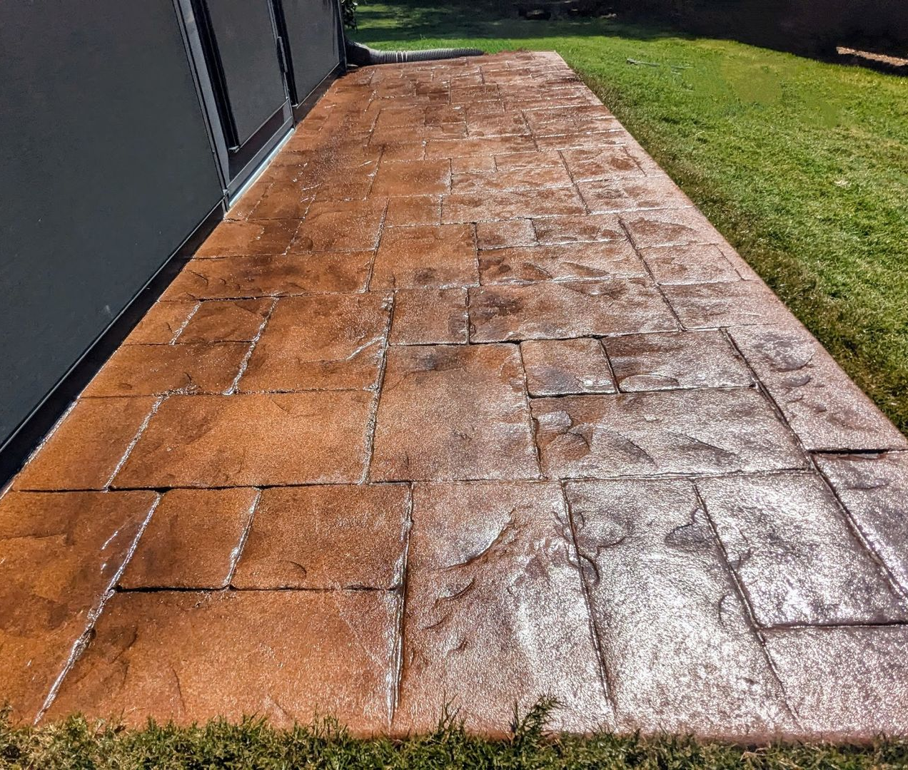 A large house with two garage doors and a concrete driveway.
