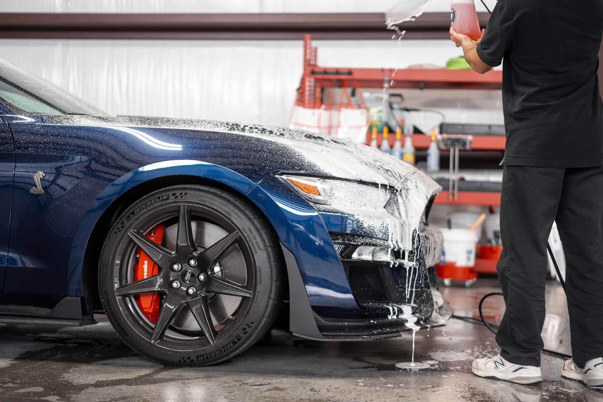 A blue corvette is parked in a parking lot