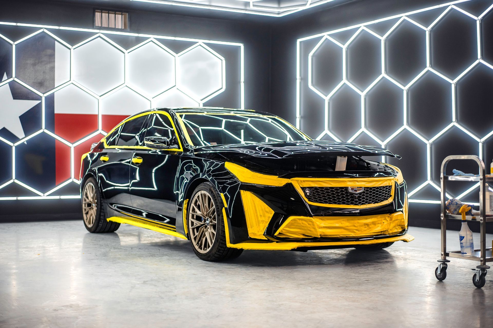 A red corvette is parked in a parking lot