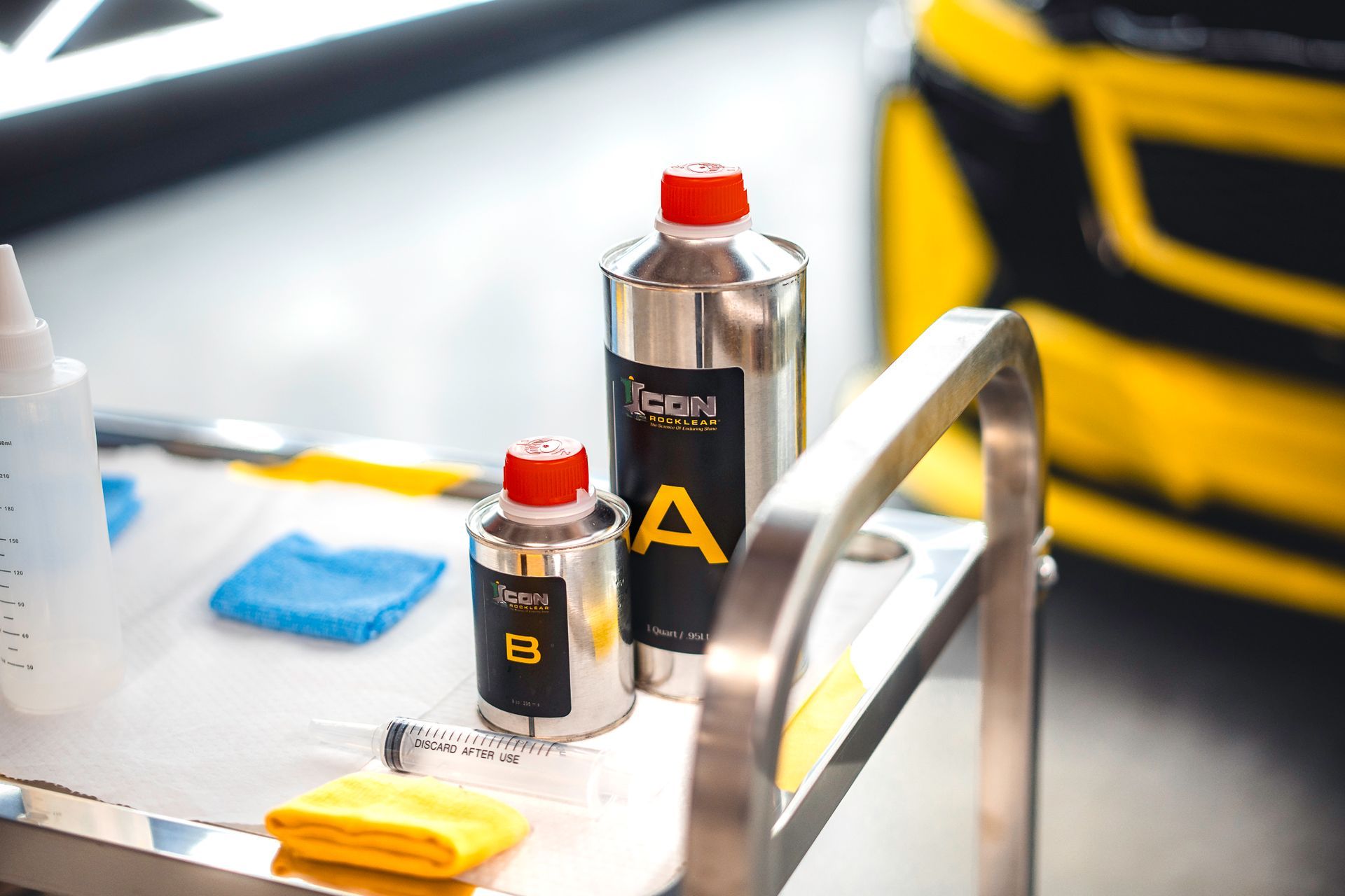 A blue car is parked in a parking lot