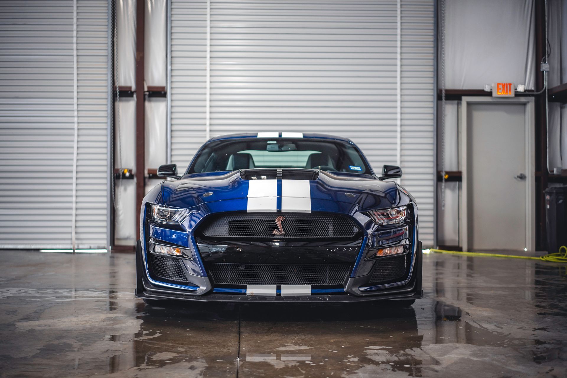A red sports car is parked in a parking lot.