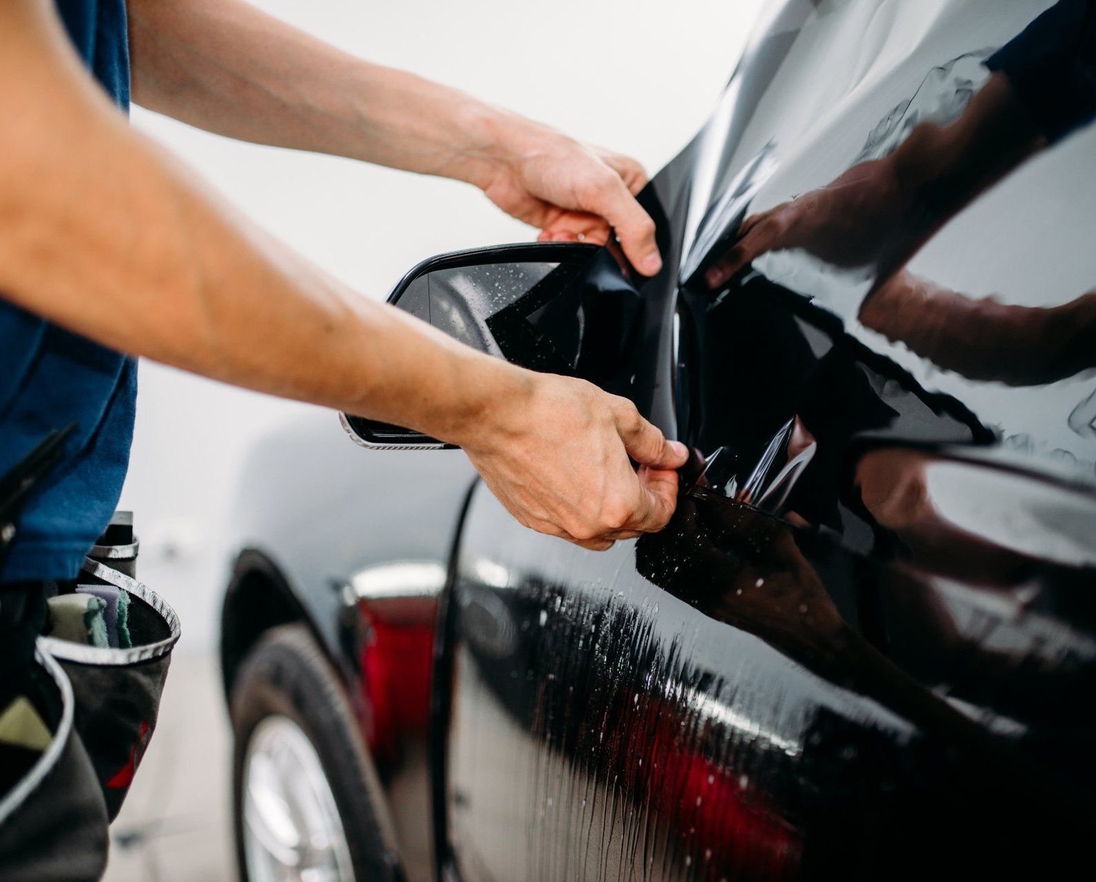 A red corvette is parked in a parking lot