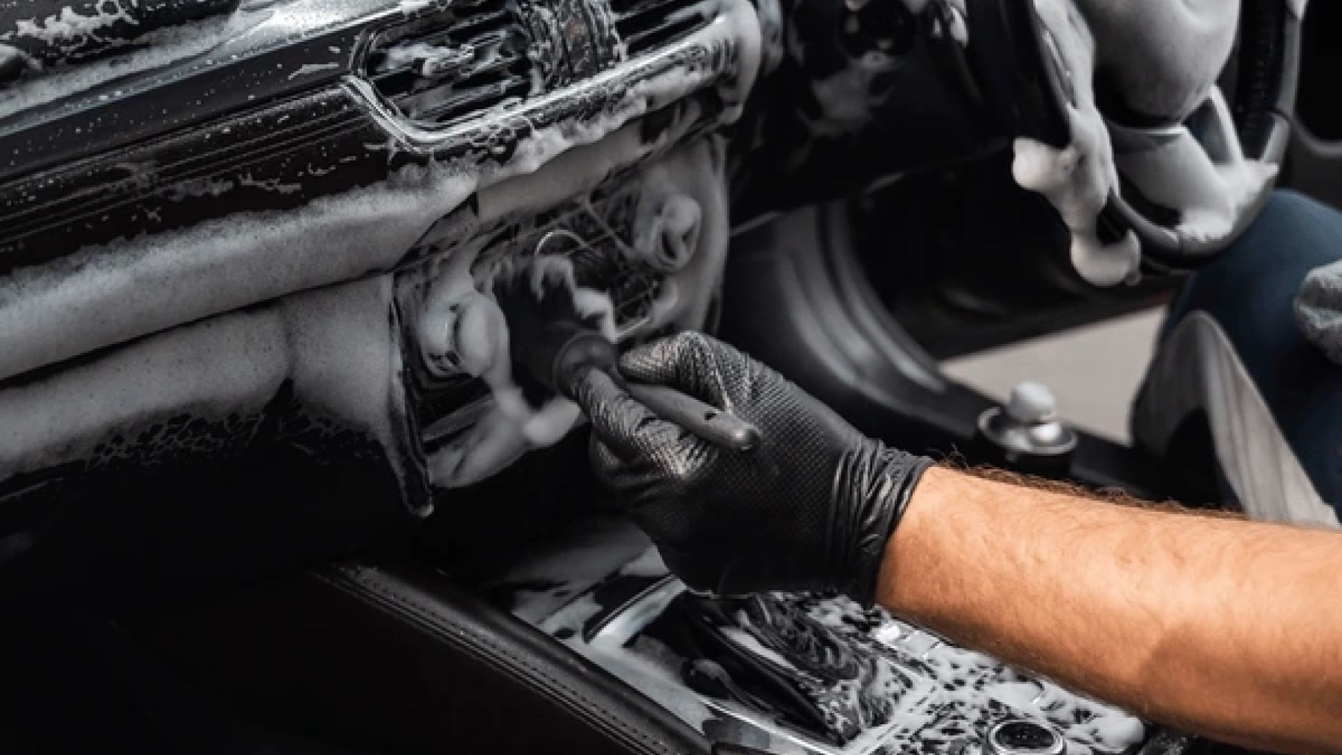 A red corvette is parked in a parking lot