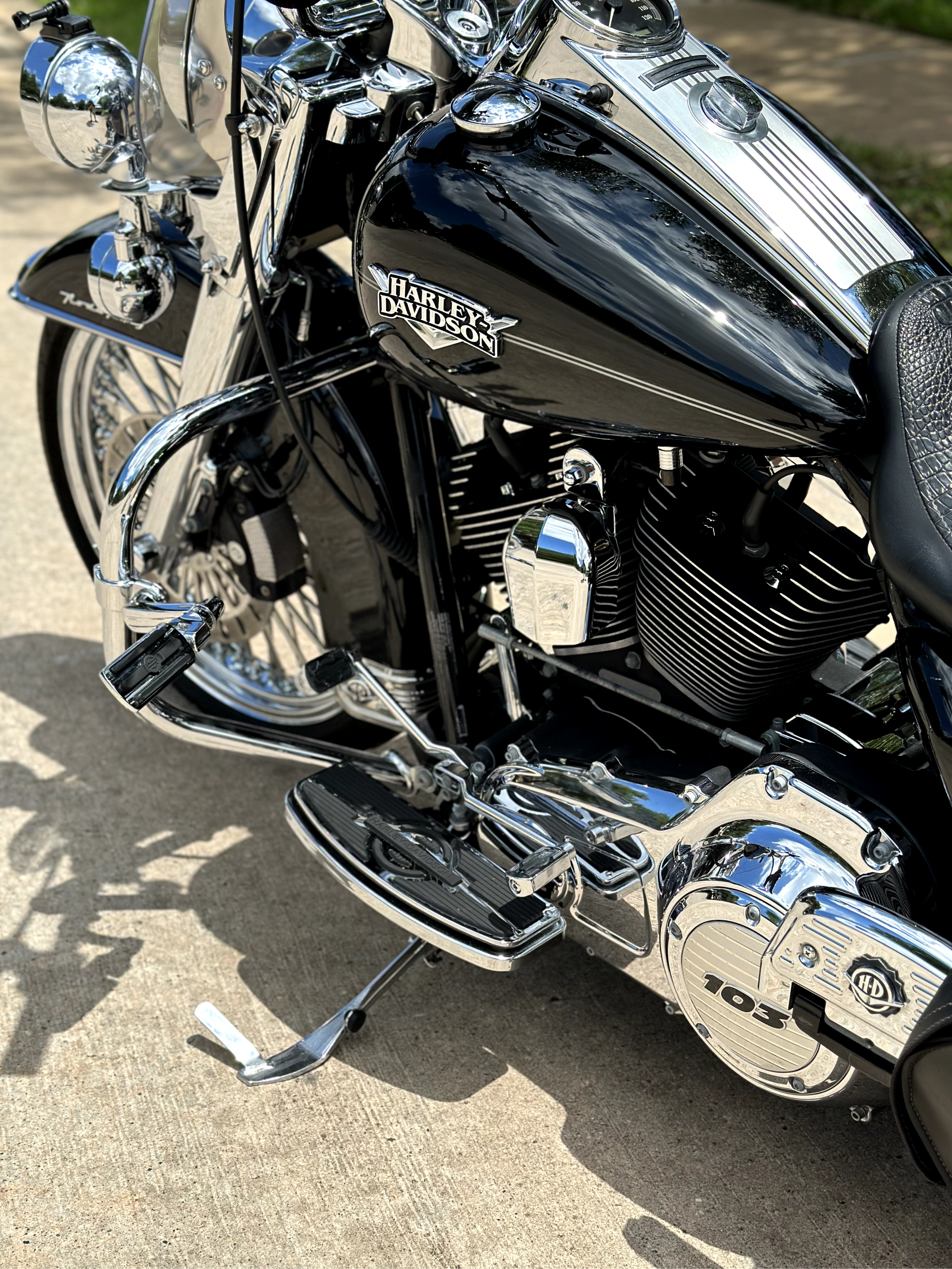 A black harley davidson motorcycle is parked on the side of the road.