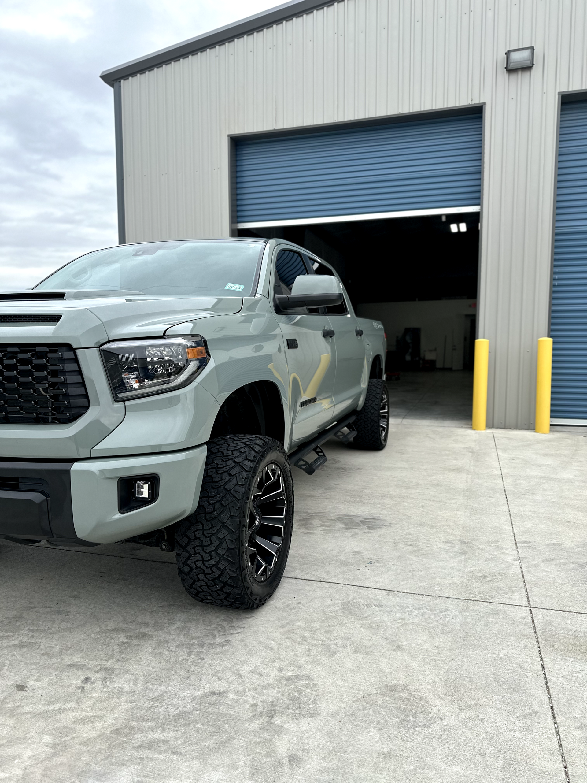 A toyota tundra is parked in front of a garage.