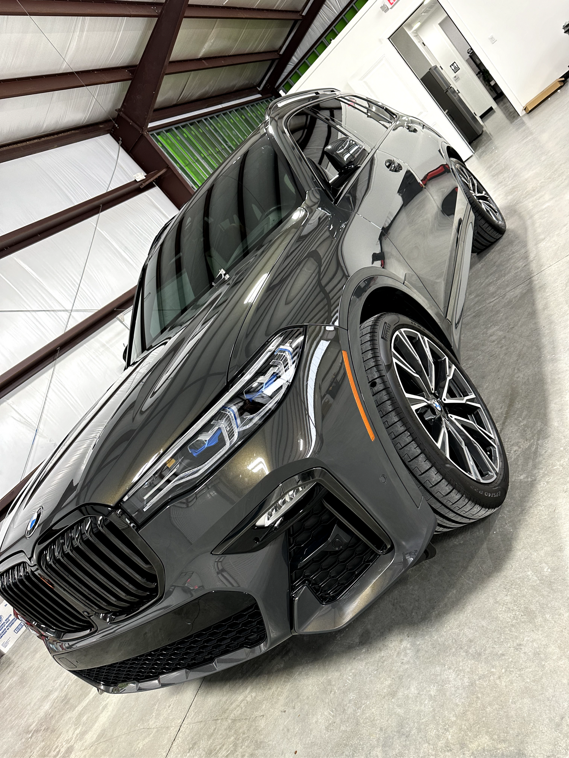 A bmw x5 is parked in a garage.