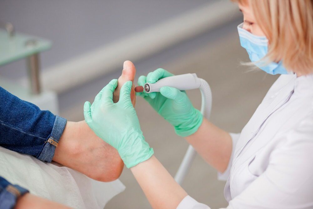 The podiatrist expertly cleanses the patient's feet — Dynamic Stride Podiatry in Nelson Baym, NSW