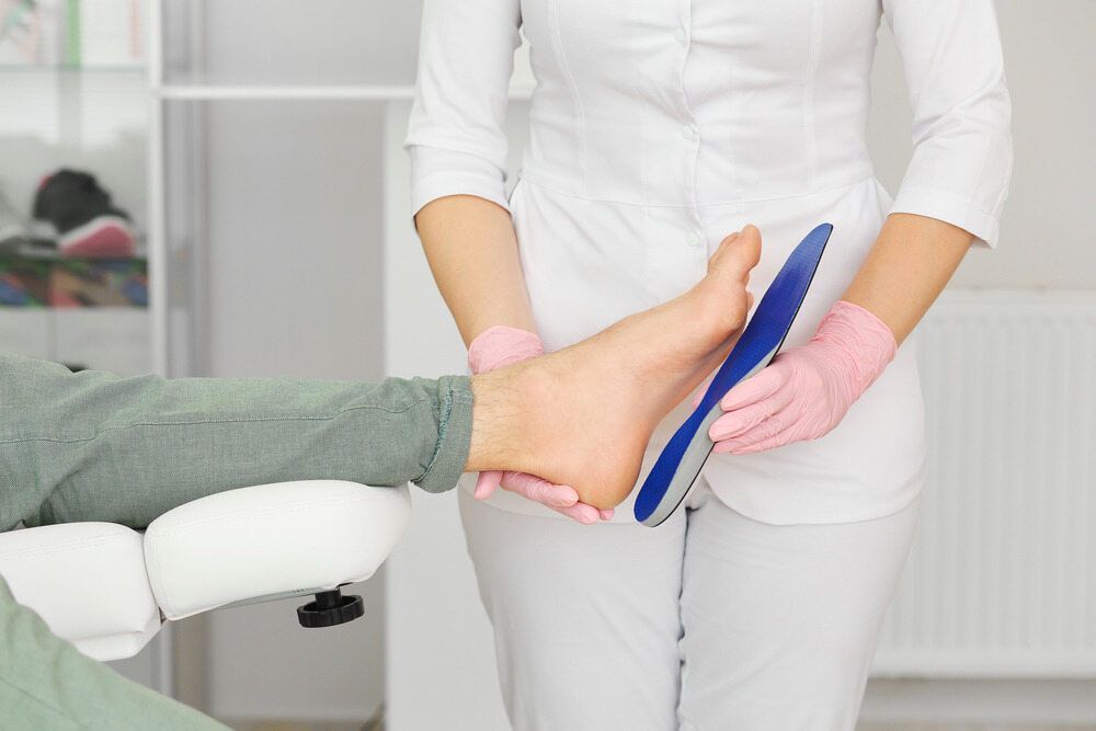 Woman holding a foot pad — Dynamic Stride Podiatry in Nelson Baym, NSW