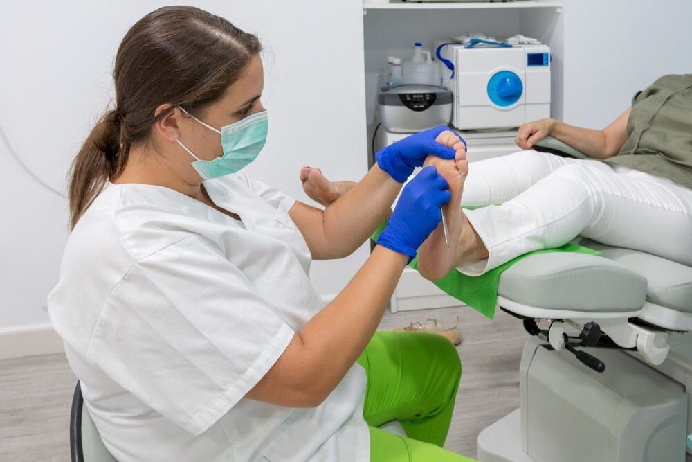 Doctor provides foot treatment to a patient — Dynamic Stride Podiatry in Nelson Baym, NSW