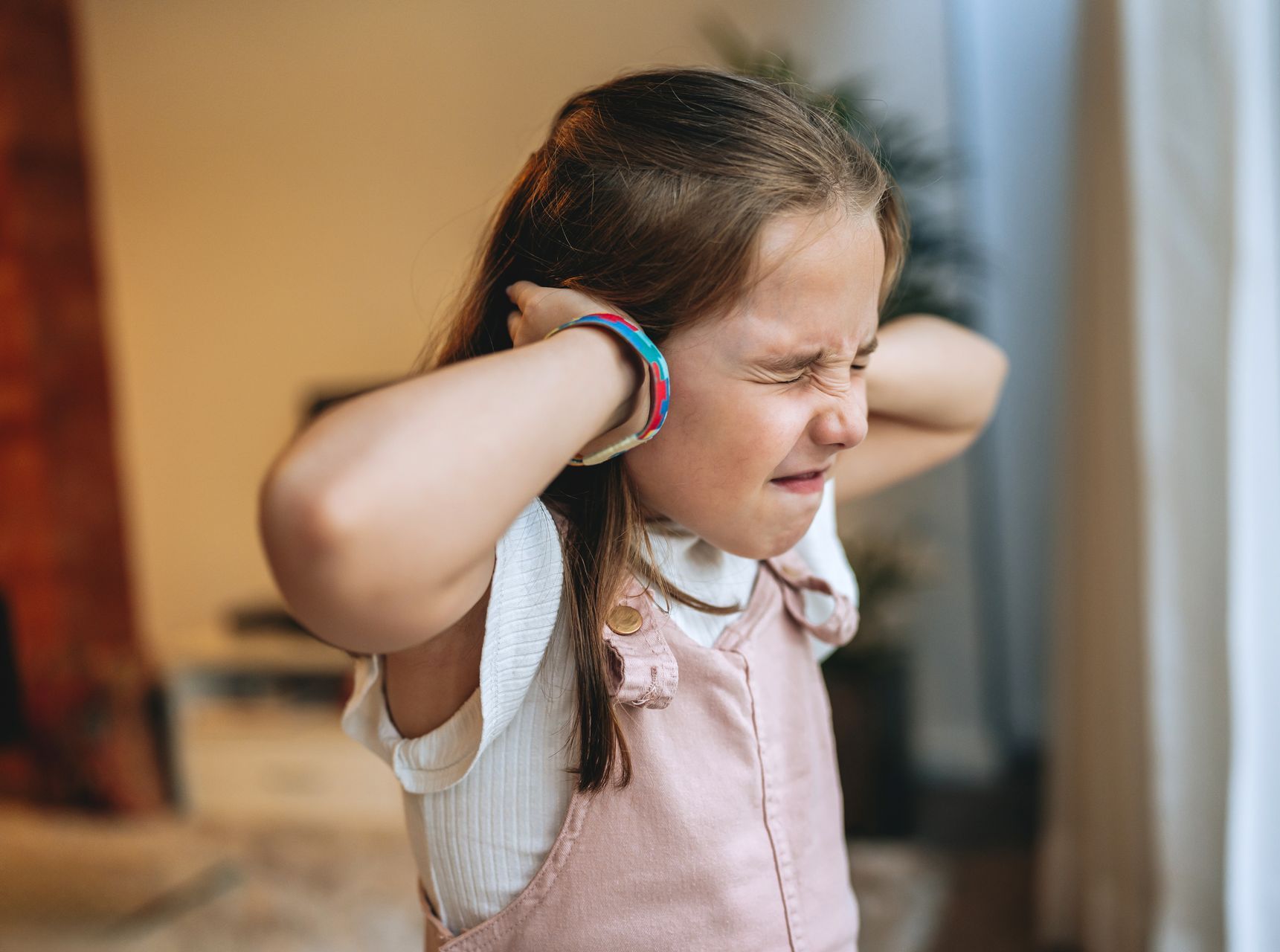 Child covering ears, representing autism support and sensory sensitivity care at Inner U Health in Westchester NY