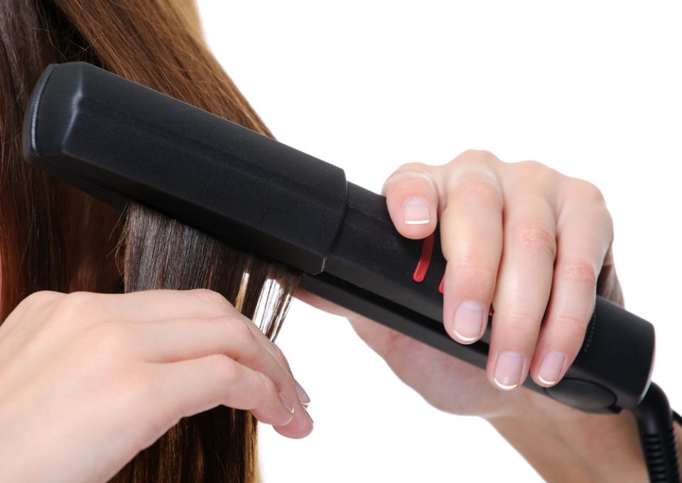 woman getting her hair straightened