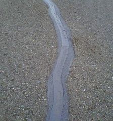 A gray concrete surface with a white line on it.