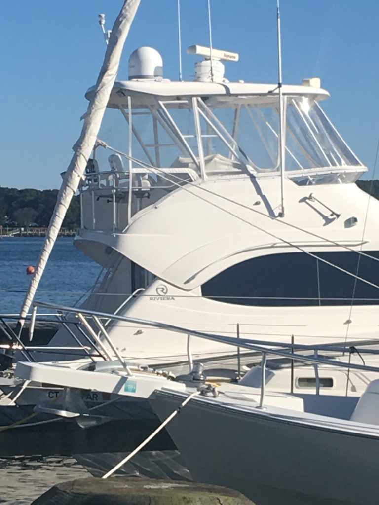 A large white boat is docked in the water