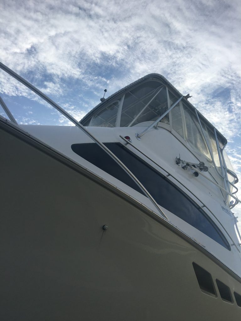 A close up of a boat with a blue sky in the background.