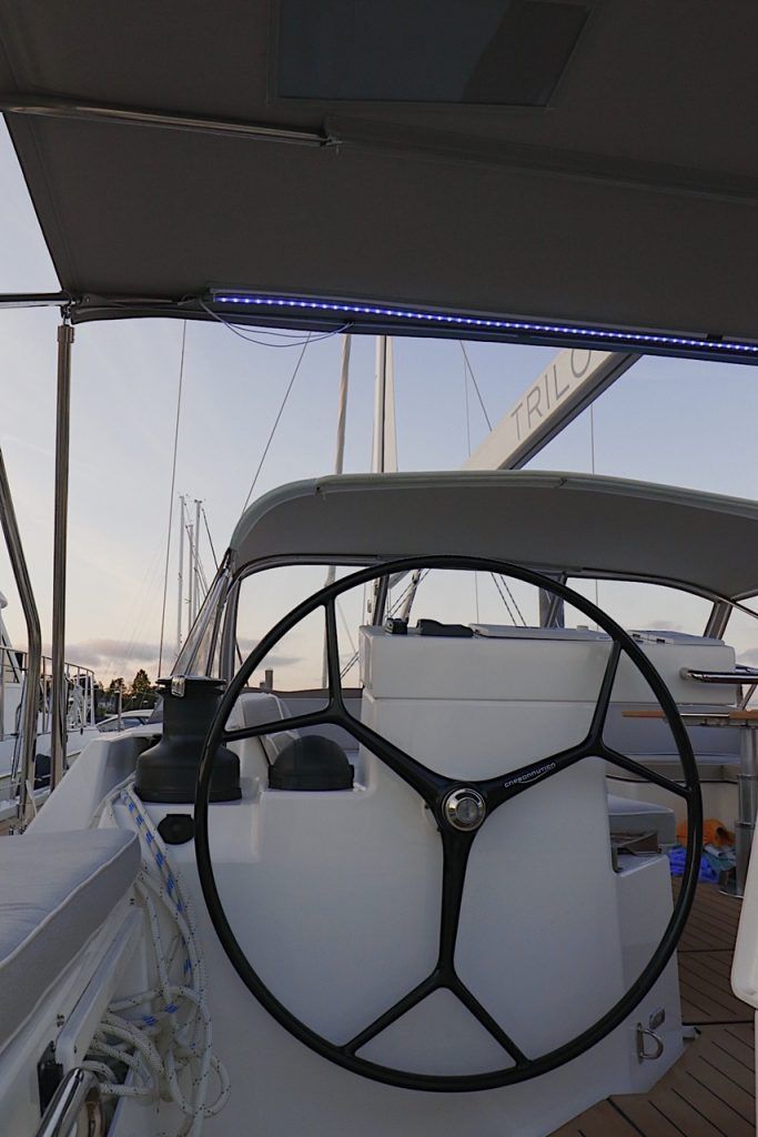a boat is docked at a marina next to a dock .
