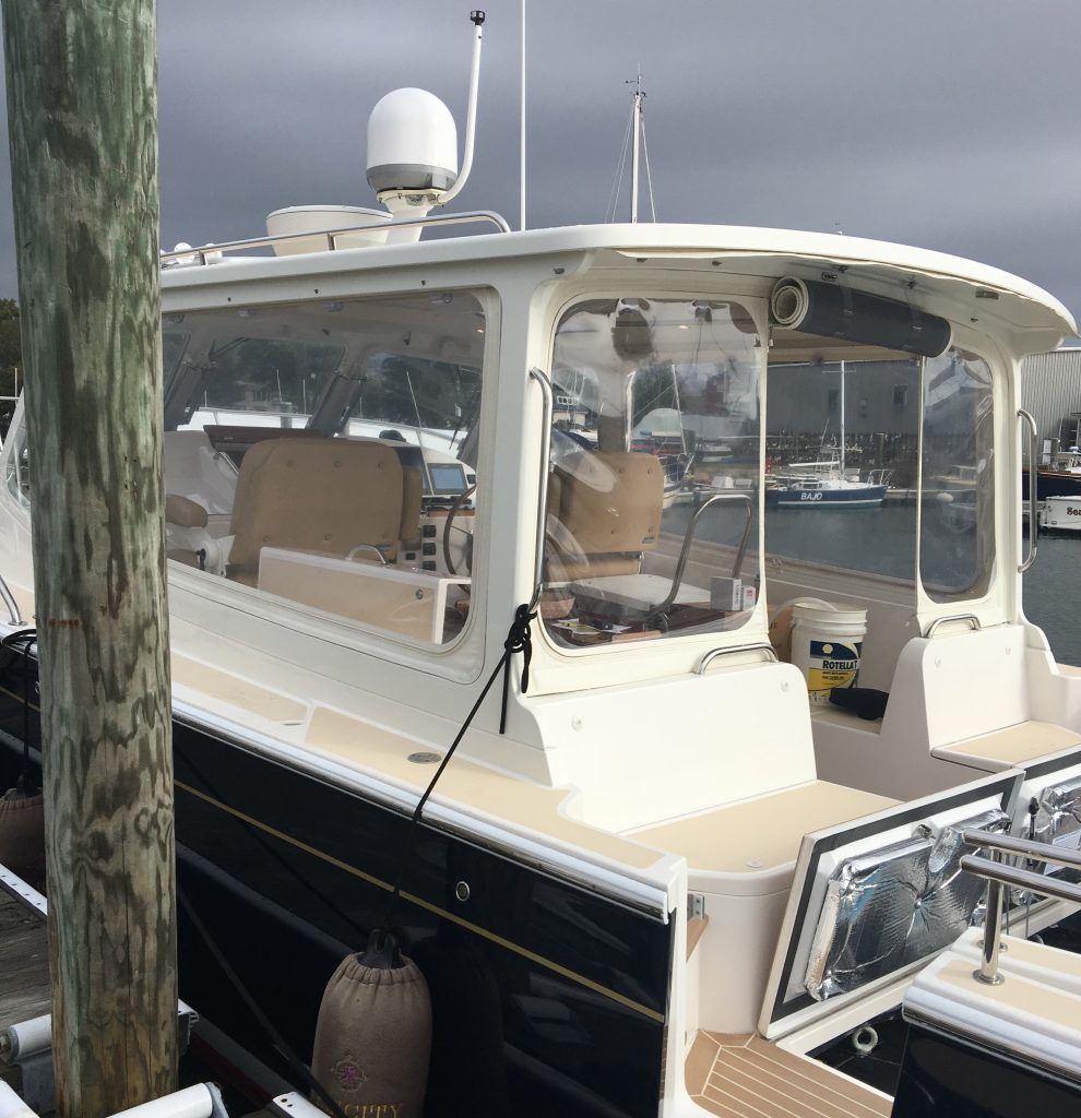 A black and white boat is docked at a dock