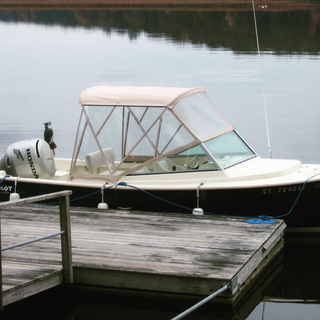 A boat is docked at a dock with a suzuki motor