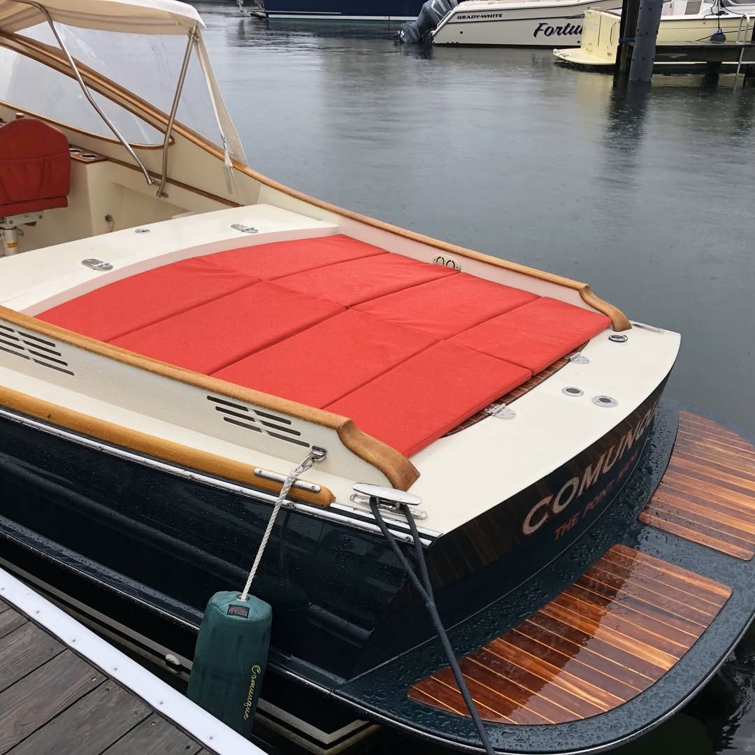 A boat with the word compass on the side of it