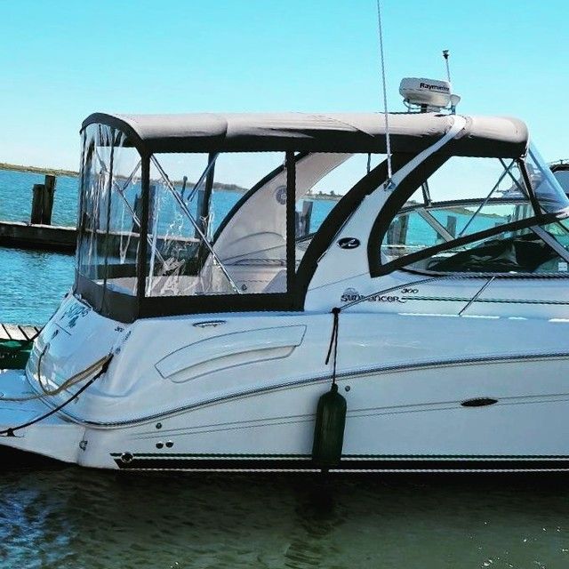 a boat is docked at a marina next to a dock .