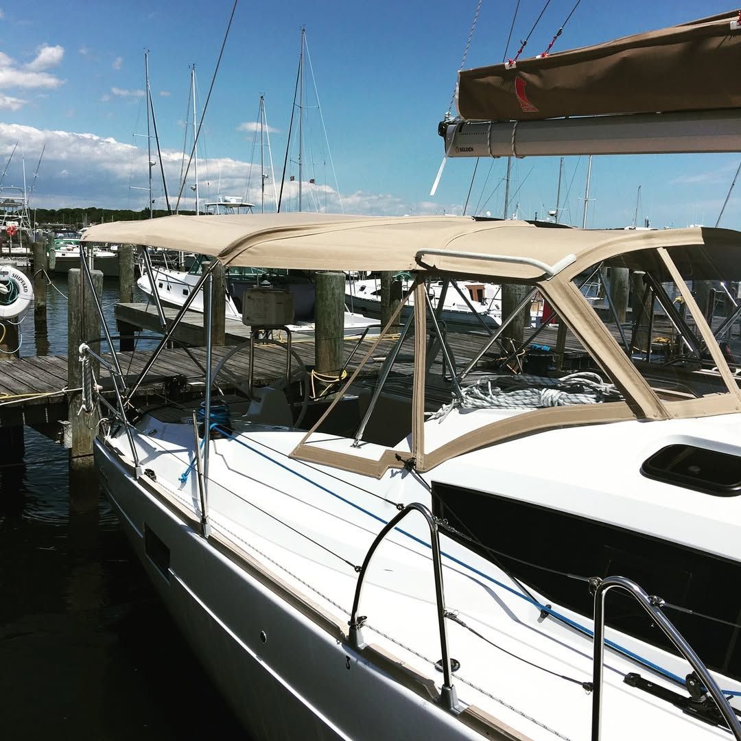 A sailboat with a canopy is docked at a dock.