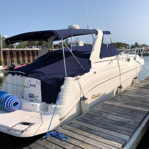 A white boat with the word grand on the back