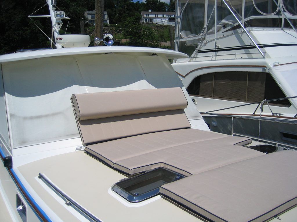A boat with a tan cushion on the top of it