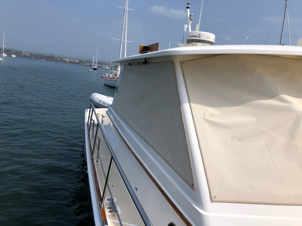 A boat is docked in the water with boats in the background