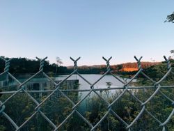A white house with a large swimming pool in front of it