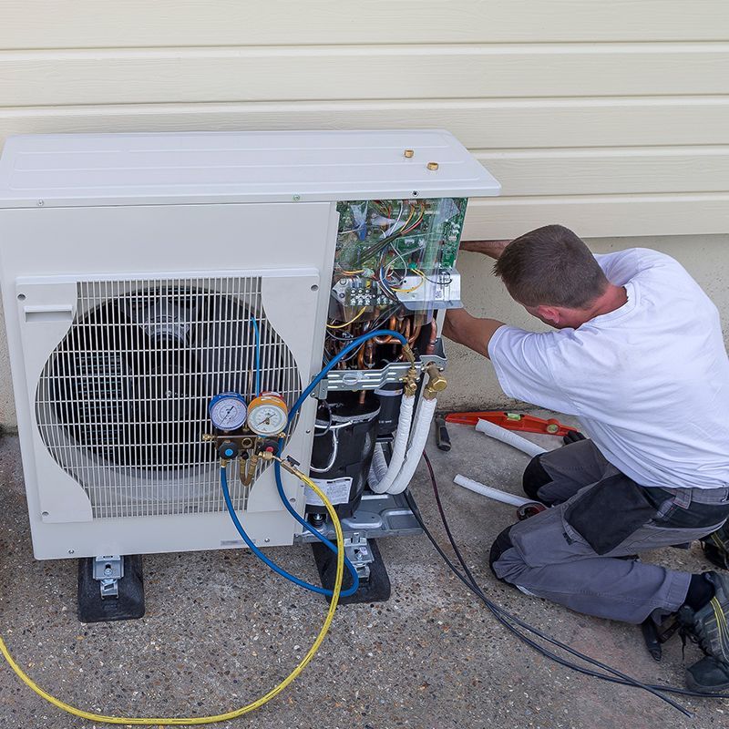 Man Checking The Heat Pump